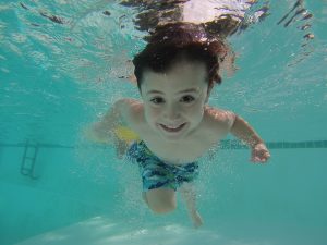 kid swimming summer holidays activity